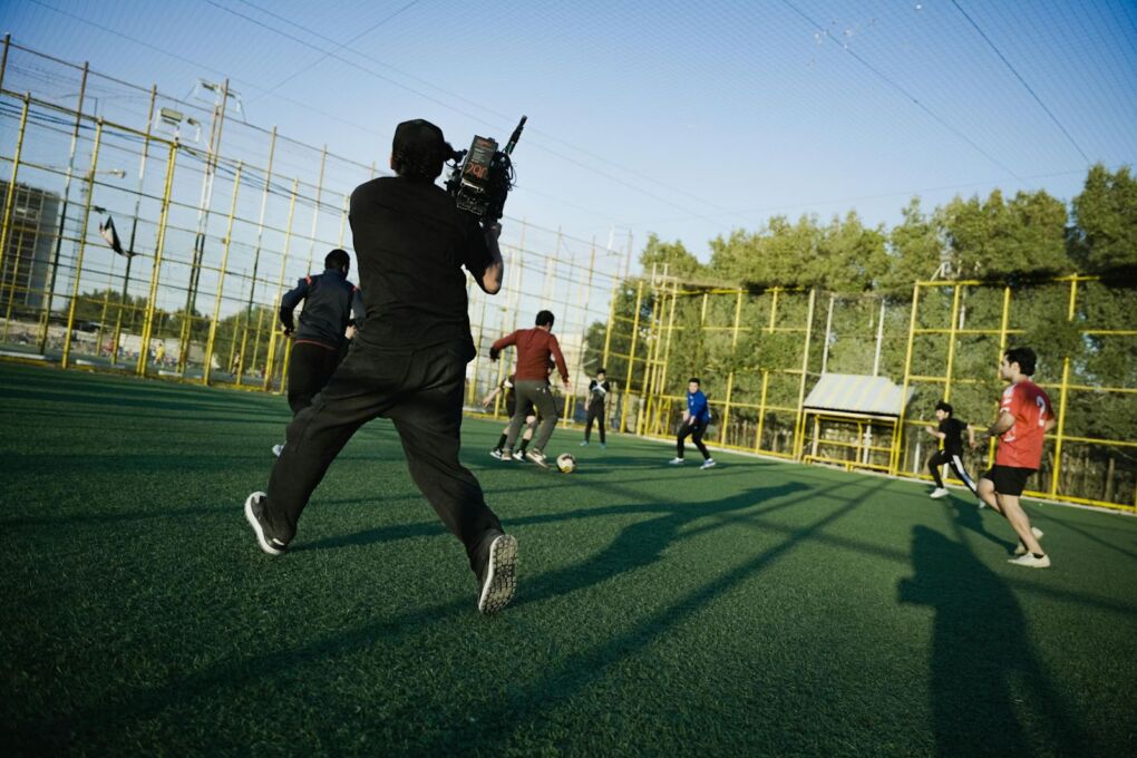 cameraman shooting a game of outdoor soccer